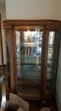 One of two antique solid-wood curio cabinets with glass shelves. 