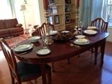 Oval dining room table and four shield-back chairs.