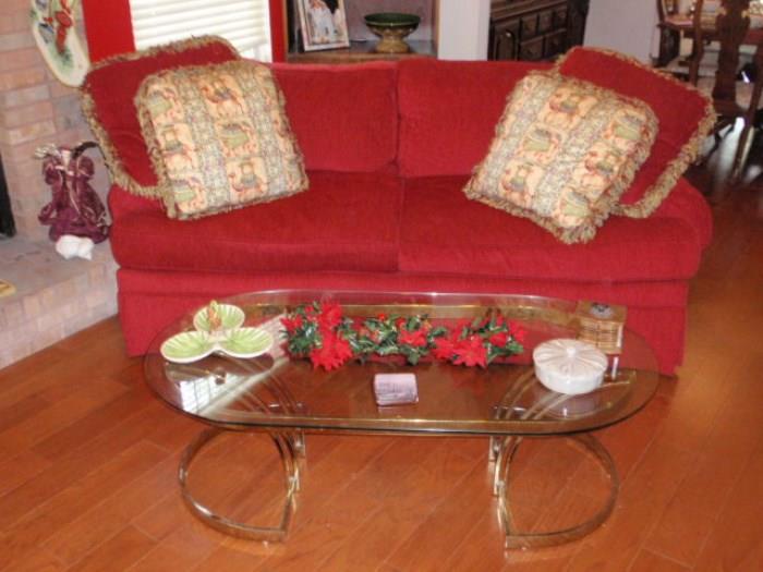 One of a pair of Red Sofas and glass & brass cocktail table.