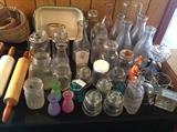 Assorted old glass items including vintage milk jugs, insulators, canning jars and so much more.