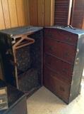 Old Steamer Trunk with original hardware and original clothes handgers.  Notice the leather strap handle which is also original.