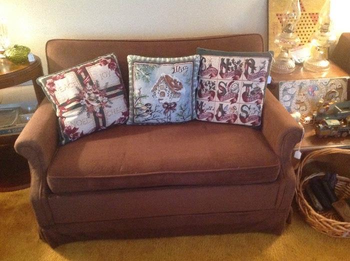 Very nice brown Love Seat that has a twin pull out mattress.  Comes with mattress (like new).