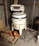 Old Kenmore wringer washer, electric hedge trimmer, boxes of fire logs, flimsy clothes rack