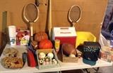 Assorted sporting goods - baseball gloves, basketballs, football, tennis rackets, cooler, Mariners ball cap