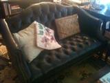 traditional camelback loveseat with tufted back and brass nailhead trim, lots of pillows, needlepoint, rug, assorted others.