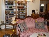 Victorian fern stands, Victorian style settee, oval marble top coffee table, books, glassware, candlesticks, swans, rabbits, etc.