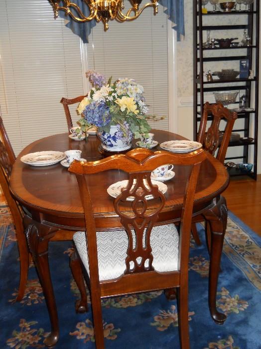 dining room table w/2 leaves, 4 chairs, Wedgwood dishes, Karman style machine made rug, etc.