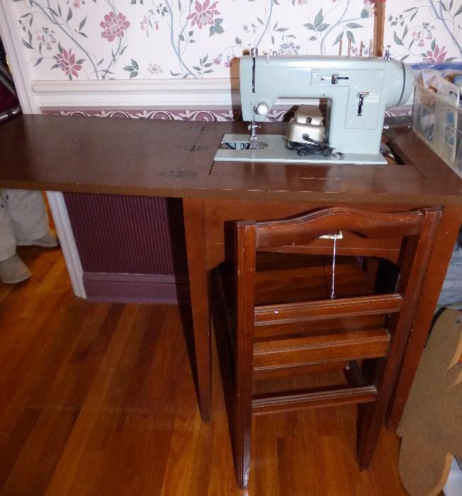 Vintage Sears Kenmore sewing machine in cabinet with chair