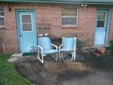 Pair outside chairs, iron pot stands, bakers rack.