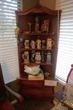 Serpentine oak antique corner cabinet.  Filled with German beer Steins. 