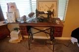 Two antique sewing machines and one sewing machine stand.
