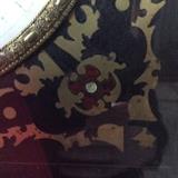 Reverse painted gold leaf glass with red and blue appointments. 