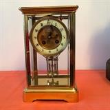 French time and strike brass 8 day clock with beveled glass inserts 6" x 5" x10" h. 1EX Spaulding & Co. Chicago + Paris stamped on back plate. Mercury pendulum. Sold with 10 mirrored base not shown. Offered at $350. Bids will be considered. 