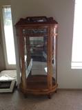 Oak curio cabinet with round glass, and bevels on top