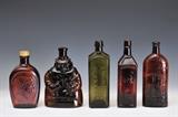 Lot 271: Group of Five Antique Bottles
including Aromatic Schnapps, Indian Chief, Warner's, Van Dunck's, and Doyles Bittlers, largest 9 3/4" high
19th century  BID ON-LINE: www.fairfieldauction.com