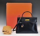 Lot 8: Hermes "Kelly" bag, navy blue leather with gold hardware and shoulder strap, original felt bag and box 13 1/2" (34cm) long,  BID ON-LINE: www.fairfieldauction.com