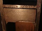 Signed initials on cabinet shelf...