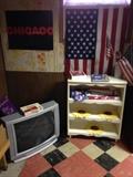 Small White Bookcase with Flag items and garden stepping stones.