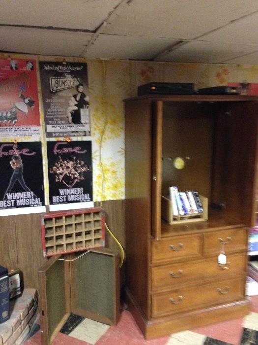 Cherry entertainment armoire in basement has 4 drawers and both front doors tuck inside when opened! Numerous playbills and box office sign from the Fisher Theatre and an old coke single bottle crate!