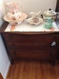 Lower in size three drawer dresser and some wash bowls and water pitchers!