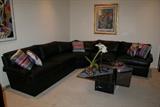 BLACK LEATHER SECTIONAL SOFA, 3 PIECES, TOTAL LENGHT 199 INCHES. ACCESSORY PILLOWS INCLUDED.