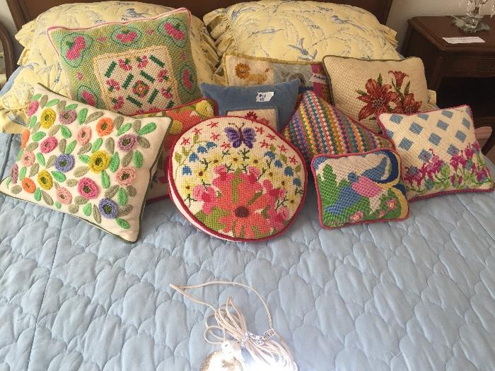 Lots of needlepoint and cross stitch hand stitched pillows.