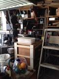 Sander, workbench, mitasaw, drill, shop lights, tools, shear blades, power cords, ladder, vintage tools, oil can, fan, wood, scrap metal, nails, screwdriver set, antique levels, antique stanley planes, electric drill, hacksaw, socket wrench, allen wrench, Combination Square, utility knife, Crosscut Saw, Wood glue, plumber's putty, dust mask, voltage tester, wheelbarrow, shovel, rake, step ladder