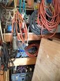 Sander, workbench, mitasaw, drill, shop lights, tools, shear blades, power cords, ladder, vintage tools, oil can, fan, wood, scrap metal, nails, screwdriver set, antique levels, antique stanley planes, electric drill, hacksaw, socket wrench, allen wrench, Combination Square, utility knife, Crosscut Saw, Wood glue, plumber's putty, dust mask, voltage tester, wheelbarrow, shovel, rake, step ladder, antique coco cola crate 