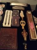 Hohner Harmonica (Blues Harp C, Preciosa C), Pen set, Finials, Asian Fan, Tooled Leather Wallet.