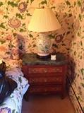 Pair of French style three drawer commodes, quilted king size headboard upholstered in Clarence House chintz, pair of Chinese porcelain lamps