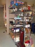 lots of storage shelving, on wheels, much miscellaneous