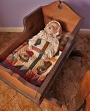 Handmade doll in toy cradle