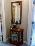 Small glass display and mirror with accessories