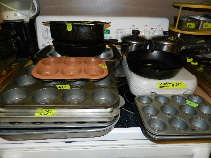 Baking sheets, muffin pans, iron skillet, casserole carrier with pyrex dish, pots, bake ware