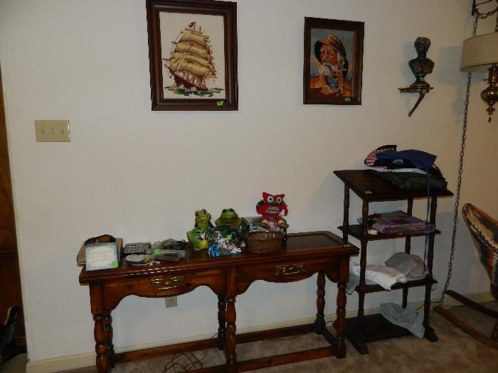 Table, small stand with shelves, pictures
