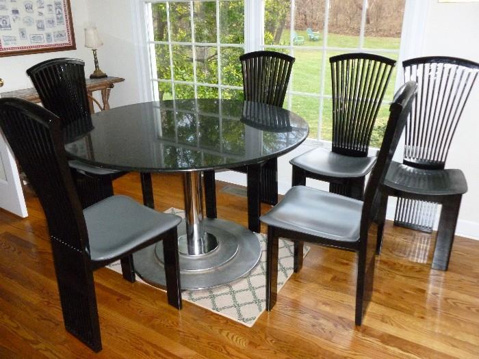 Fabulous Granite-top table w/chrome & cast base & 6 leather seat chairs.