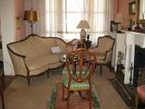 View of the Sallley Living Room, with French Settee and Chair, Bronzed Floor Lamp, Chinese Rug, Shield-back Chairs, Brass Fire Fender and More!