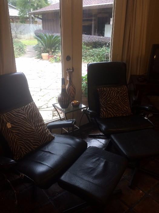 Black modern chairs with ottomans