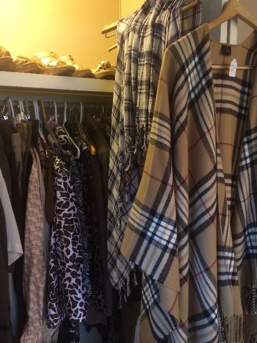 Closets of clothes including Burberry shawl cape
