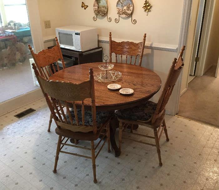 Round Oak Kitchen Table and sturdy chairs. Microwave Oven, etc.