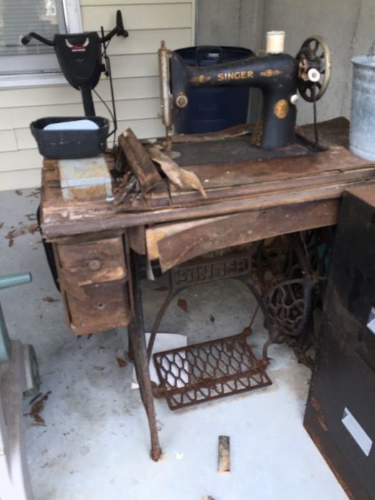 Old Singer Sewing Machine and damaged table.