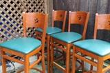 4 new bar stools with brass foot plates, star backs and green seats $200.