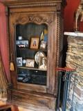 Oak armoire with metal grate door.