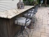 outdoor bar  and 4 iron stools
