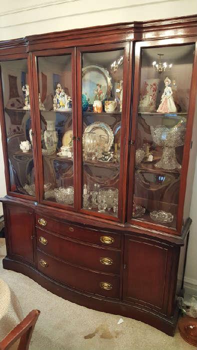 Bent glass china cabinet full of great crystal and porcelain items....hutch (top) is removable (bottom would be a nice more formal flatscreen stand!)
