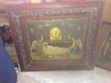Antique religious artwork with ornate frame