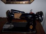 Close up of Singere sewing machine in cabinet.
