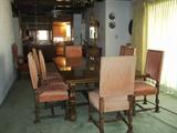 1920's 8ft.table with the 2 leaves it makes the table 11ft. and has 12 upholstered chairs with bold nail head trim. Beautifully carved.