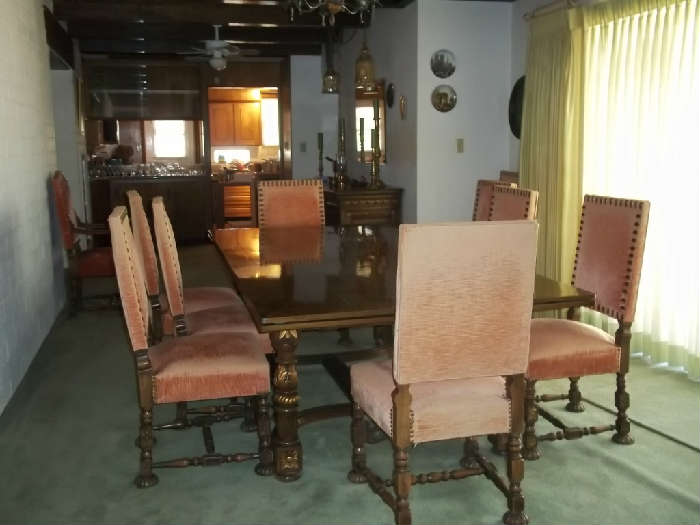 1920's 8ft.table with the 2 leaves  it makes the table 11ft. and has 12 upholstered  chairs with bold nail head trim. Beautifully carved.
