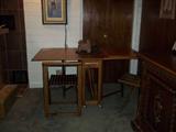This is another midcentury modern table and 4 chairs. The table is a drop leaf and the chairs are stored inside.